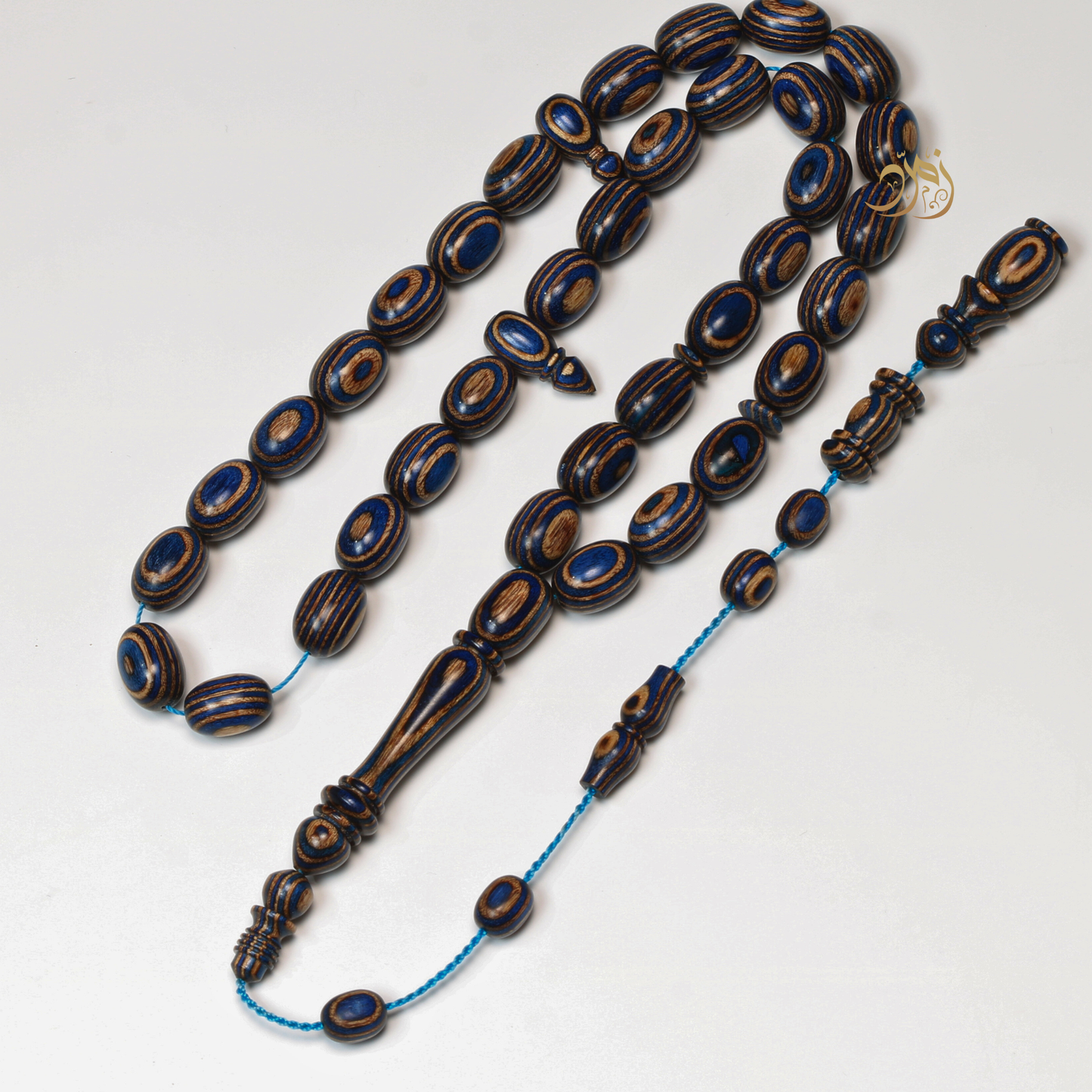 سبحة خشب كافور مضغوط أزرق عيون– 35 خرزة بيض حمام